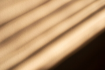 Beige background from soft rays of stripes. Soft warm light diagonal stripes. Abstraction background. 