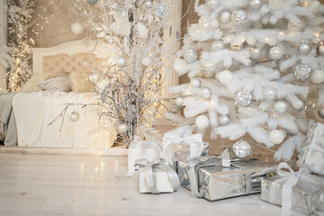 New Year's holiday, mood, Stylish New Year's minimalistic interior, Gifts and wrapped gifts under the Christmas tree. large white bedroom with white bed