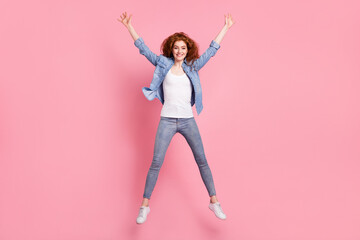 Fototapeta na wymiar Full length photo of cheerful nice young woman jump up air smile active sportive isolated on pink color background