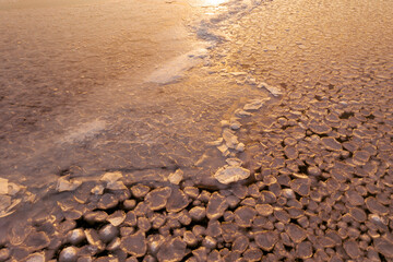 winter landscape, river covered with ice of unusual shape, pure frozen water creates beautiful patterns