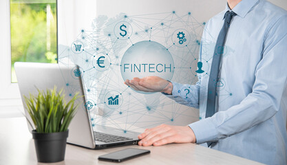 Businessman hold Fintech -financial technology concept.Business investment banking payment. Cryptocurrency investment and digital money. Business concept on virtual screen.