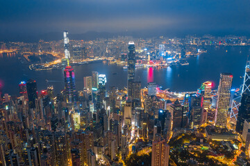 Fototapeta na wymiar Aerial shot a Thousand of skyscraper on two side of Victoria Harbour of Hong Kong. View from the Peak at night.