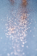 Blue festive background. Abstract scattering of gold sparkles. Christmas Winter backdrop, selective focus