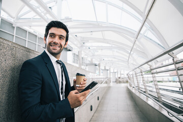 Businessman leadership talking with customer and drink cup of coffee outside near cityscape and dreaming for bigger projects with business assistants outside office. Finance portrait