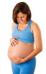 pregnant woman looks at her belly and smiles. isolated background. High quality photo