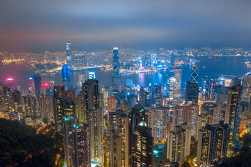 Aerial shot a Victoria Harbor of Hong Kong at night time.