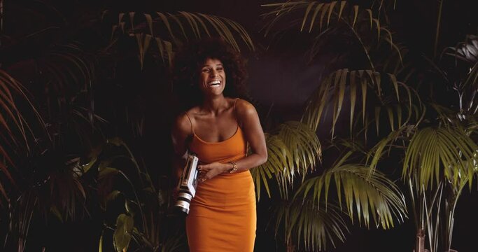 Laughing Woman With Afro Hair In Orange Using Vintage 8Mm Camera
