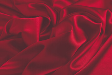 Obraz premium Red silk or satin luxury fabric texture can use as abstract background. Top view.