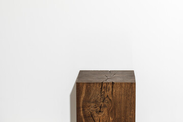 Solid oak wood stump against white wall. Wood coffee table