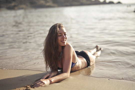 portrait of smiling young woman at the beach