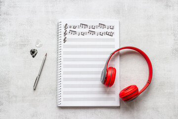 Handwritten music sheets and headphones, top view. Compose music concept