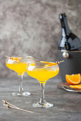 Festive Alcohol cocktail Mimosa with Orange juice and cold Champagne or sparkling Wine in glasses on table.