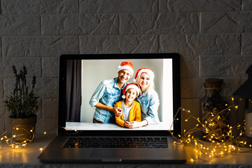 Fototapeta na wymiar young family video call smiling and looking at webcam web, lovers greet friends merry christmas and happy new year
