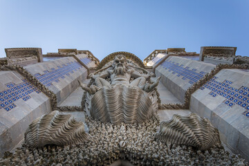 A picture of the triton at the entrance of the Pena Palace in Sintra, Portugal from below to top with the details of the half man half fish  mythological monster.  