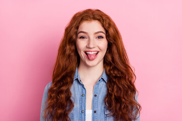 Photo of young attractive girl grimace happy positive smile tongue-out childish isolated over pink...