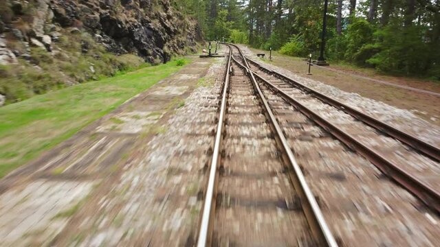 Front view of a moving train on old railway.	
