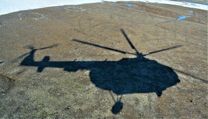 the shadow of a flying helicopter © Руслан Чунаев