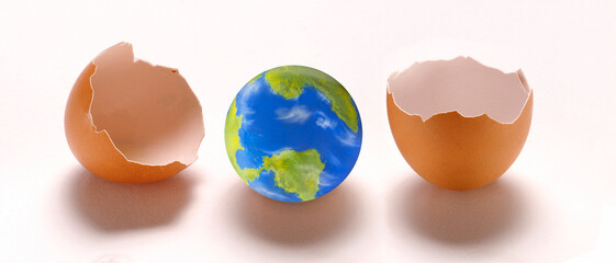 A new planet is borning concept from egg shell on white background, ( The planet earth is a...