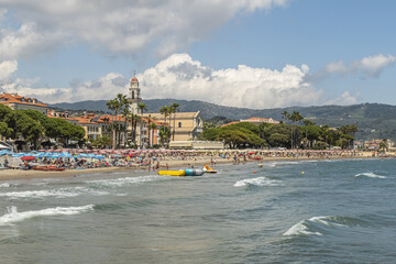 The beach of Diano Marina with a beautiful church in background