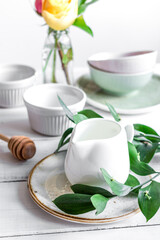 ceramic tableware with flowers on white background