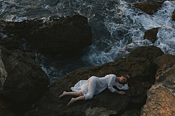 beautiful young woman in white wedding dress on sea shore wet hair landscape