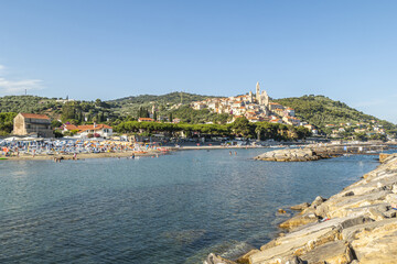 Naklejka na ściany i meble Cervo beach with its characteristic rocks and the beautiful town in the background