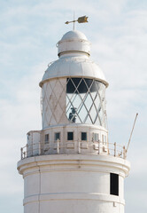 Lighthouse. Close Up of a lighthouse  with a cloudy sky in the background.