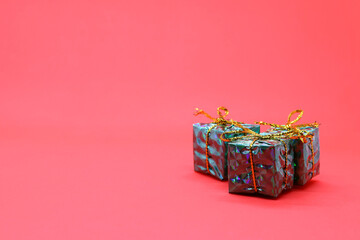 Gift boxes for the new year on a pink background, holiday gifts