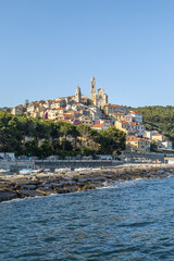 Cervo beach with its characteristic rocks and the beautiful town in the background