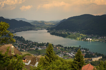 Fototapeta na wymiar Panoramic view of the town of Pörtschach am Wörther See beside Wörthersee lake on a cloudy day in summer, Austria