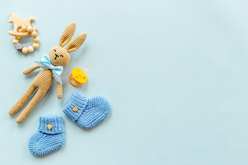 Kids toy knitted rabbit with baby booties shoes, top view