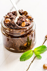 Homemade cosmetics with scrub and coffee beans on desk background