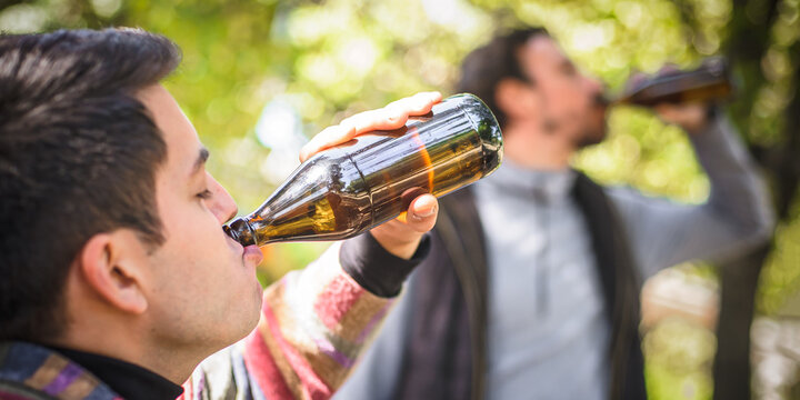 Two men chugging beer. Express drinking and fast get drunk
