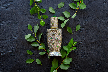Silver bottle of arabian oud perfume or agar wood oil