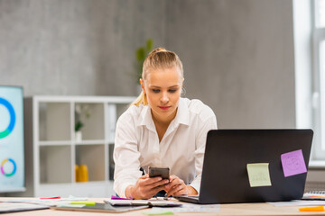 Workplace of freelance worker or a student girl at home office. Young woman works using computer and other devices. Remote job concept.