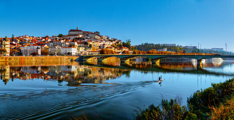 Canoeist doing sport at the end of the day on the River Mondego near the city of Coimbra, Portugal.
