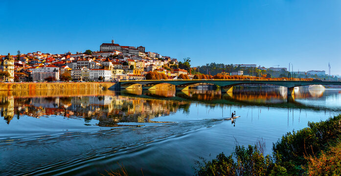Canoeist doing sport at the end of the day on the River Mondego near the city of Coimbra, Portugal.
