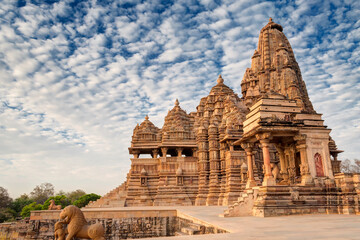 Beautiful image of Kandariya Mahadeva temple, Khajuraho, Madhyapradesh, India with blue sky and fluffy clouds in the background, It is worldwide famous ancient temples, UNESCO world heritage site.