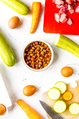 organic pets food with eggs, zucchini and carrot white background top view