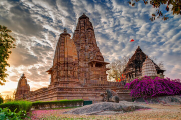 Beautiful image of Eastern Temples of Khajuraho, Madhyapradesh, India with blue sky and fluffy...