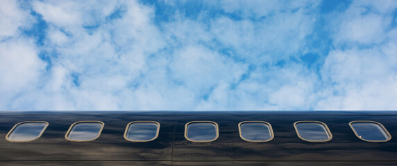 Close up of an airplane windows of private business jet, panoramic layout