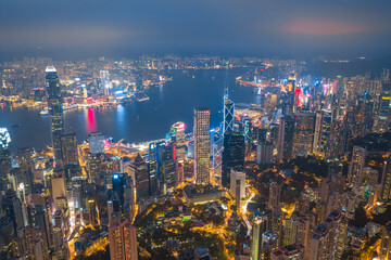 Aerial shot a Thousand of skyscraper on two side of Victoria Harbour of Hong Kong. View from the Peak at night.