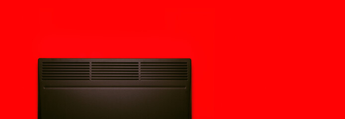 Heating convector over  red background, panoramic layout