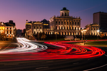 Fototapeta na wymiar Long exposure cityscape at night with classic buildings and many car light trails in front, Moscow