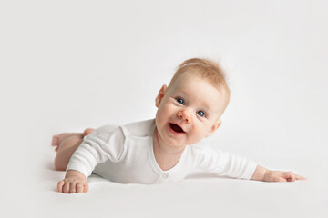 Fototapeta premium smiling baby in white clothes on light background