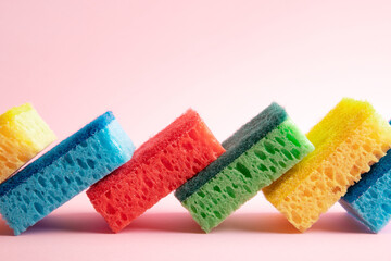 multi-colored washing sponges over pink background