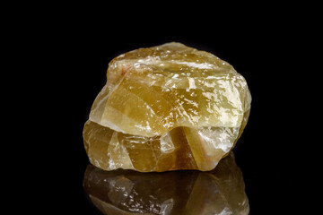 Macro mineral stone yellow Calcite on a black background