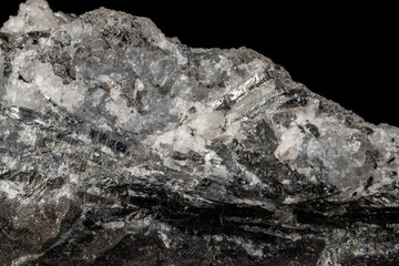 Macro mineral stone Stibnite quartz on a black background