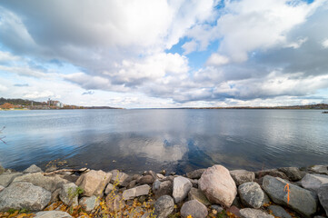 Barrie waterfront centennial park  lakeshore  path with green grass and fall colour trees   blue...