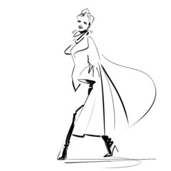 Fashion model turning on the runway wearing a turban, somptueus haute couture coat and thigh high boots